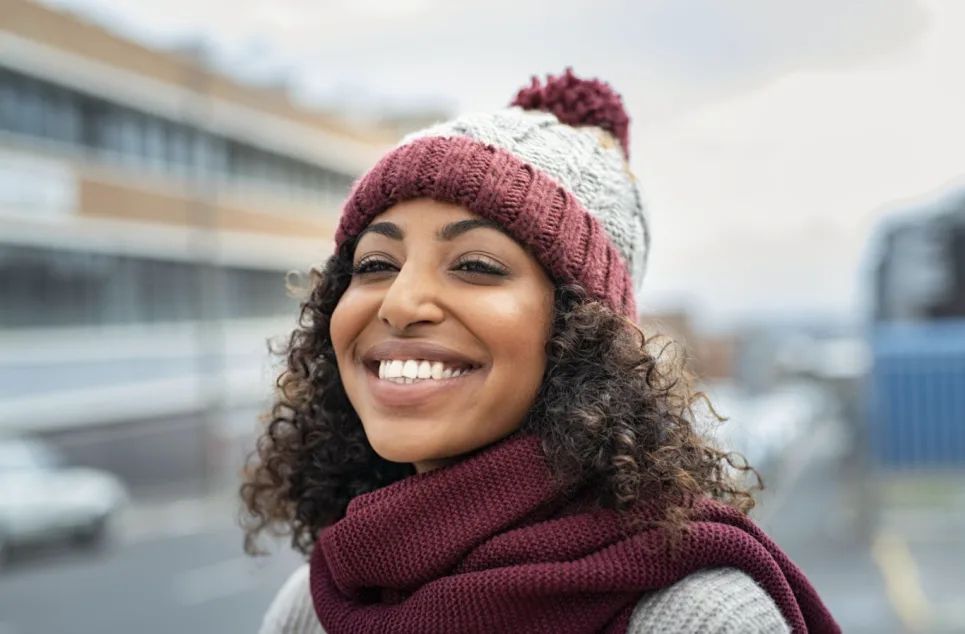 Smiling girl in winter hat.png